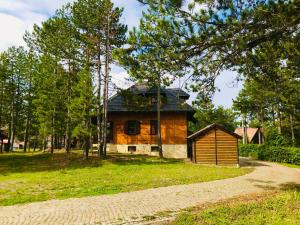 a house on a hill with a dirt road at vila Family apartman 2 in Kaludjerske Bare