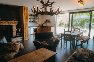 a living room with a table and a dining room at Zážitkový Ranč Nevada in Velká Lečice