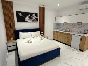 a bedroom with a large bed and a kitchen at Full Moon Apartments in Ksamil +79 photos