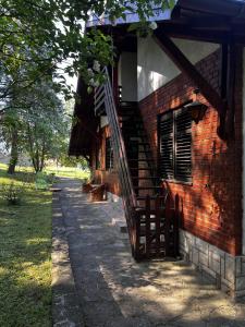 a brick building with a staircase on the side of it at Ostojino osoje in Šarani