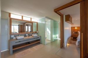 a bathroom with two sinks and a mirror at Hotel Spa Nau Royal in Camburi