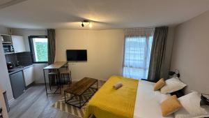 a bedroom with a bed and a kitchen with a table at Appartement O'501 in Avignon