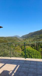 a metal fence with a view of a mountain at Amazing View Studio in Chorepískopoi +4 photos