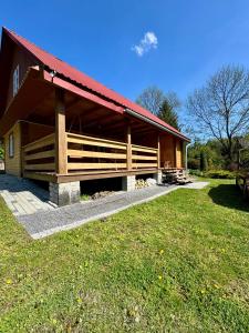 a large wooden building with a red roof at Miejsce w lesie in Stara Huta