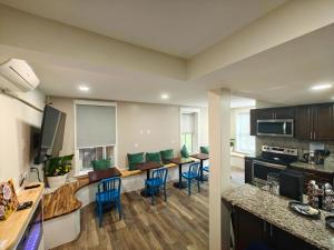 a kitchen and dining room with blue chairs in a room at I Street Capsule Hostel in Washington, D.C.