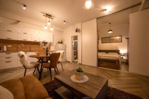 a living room with a couch and a table and a bedroom at Madona di Sinj in Sinj
