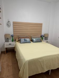 a bedroom with a large bed with two blue pillows at Albir Adventino LOVE in Albir +51 photos