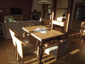 a wooden table and chairs in a living room at Ferienhaus Bressler in Vöhl +7 photos