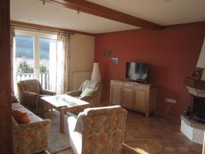 a living room with a couch and chairs and a television at Ferienhaus Bressler in Vöhl