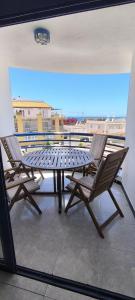 a table and chairs on a balcony with a view at BEACHITO Puerto Naos in Puerto Naos