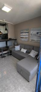 a living room with a couch and a piano at BEACHITO Puerto Naos in Puerto Naos +29 photos