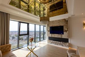 a living room with a large wall of windows at HANZA TOWER GOLD 19th Floor in Szczecin