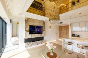 a living room with a fireplace and a tv at HANZA TOWER GOLD 19th Floor in Szczecin
