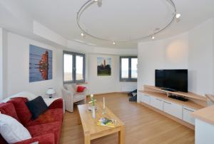 TV a/nebo společenská místnost v ubytování Ferienhaus Leuchtturm