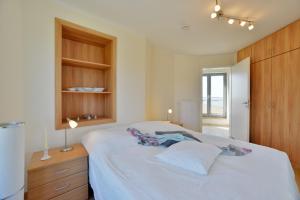 Postel nebo postele na pokoji v ubytování Ferienhaus Leuchtturm