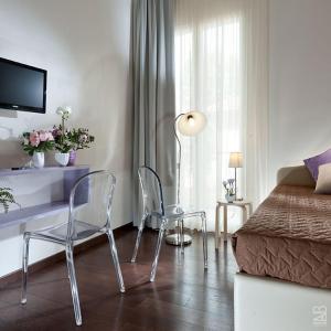 a bedroom with a desk and chairs and a bed at Hotel Estense in Bellaria-Igea Marina