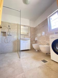 a bathroom with a shower and a sink and a toilet at Holiday Home Linet in Funtana