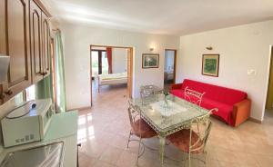 a living room with a red couch and a table at Holiday Home Linet in Funtana