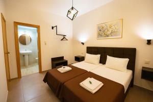 a bedroom with a bed and a bathroom with a sink at Αvra Strymonikou in Stavros