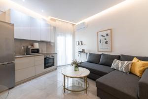 a living room with a couch and a table at Agora by Rapsani beach ! in Kavála