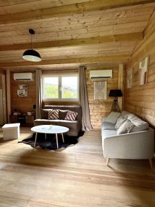 a living room with a couch and a table at Ô Village in Giromagny +25 photos