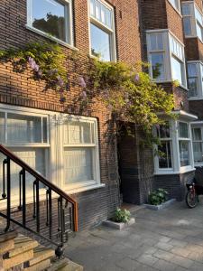 a brick building with flowers on the side of it at 185m2 groot appartement met tuin in City Centre in Amsterdam