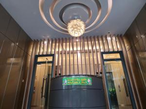 a lobby with a large chandelier in a building at Sky Suites klcc in Kuala Lumpur