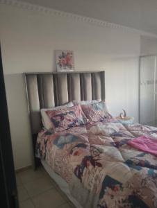 a bedroom with a bed with a quilt on it at Khetshane Consortium private park and restaurants in Ntswanahatshe