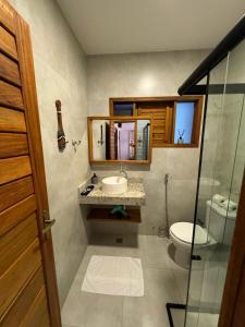 um banheiro com uma pia, um vaso sanitário e um espelho em Casa Amazing Jeri em Jericoacoara