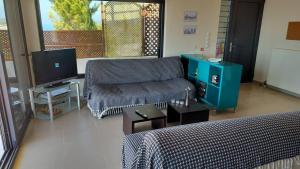 a living room with a couch and a tv at Casa del Mar in Preveza