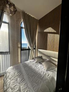 a bedroom with a large bed with a large window at Marco Polo by Alina365 in La Manga del Mar Menor