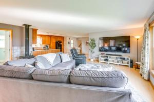 a living room with a large couch and a kitchen at Bay Views Peaceful Acadia National Park Getaway! in Steuben
