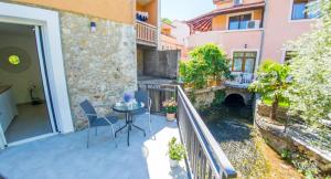 a balcony of a building with a table and chairs at Stari View-Free Parking in Mostar
