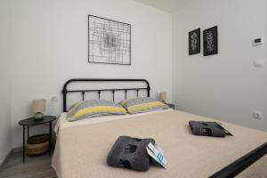 a bedroom with a bed with two towels on it at Apartment Grey in Medulin