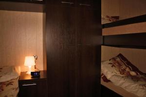 a bedroom with a bed and a night stand with a lamp at Ośrodek Niebiańska Plaża in Sarbinowo