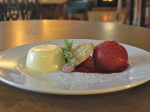 a white plate with desserts on a table at Edinbane Inn in Edinbain
