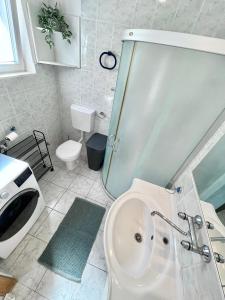 a white bathroom with a sink and a toilet at Charming Apartments Dalmatian Misto Čiovo in Okrug Donji