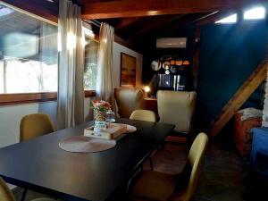 a dining room with a black table and chairs at Kuća za odmor DRAVA LIFE in Molve