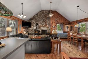 a kitchen and living room with a stone wall at Rustic retreat w kitchen & deck in Great Cacapon