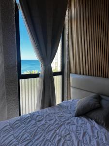 a bedroom with a window with a view of the ocean at Marco Polo by Alina365 in La Manga del Mar Menor