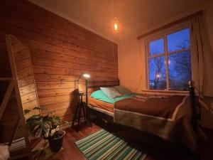 a bedroom with a bed and a window at Solkot Cottage Homestay in Reykjavík