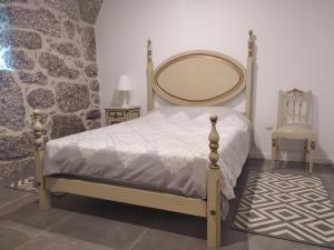 a bedroom with a bed with a mirror on the wall at Casa do Oitão in Vieira do Minho