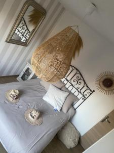 a bedroom with a bed with a lamp and pillows at Chambre des Tours in Mont-Saint-Éloi