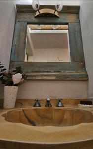 a bathroom sink with a mirror above it at Casa Norma Casco Historico in Chascomús