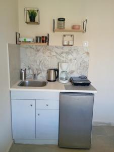 a kitchen with a sink and a counter top at Elenas Garden in Kavos +29 photos