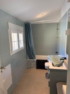 a bathroom with a tub and a toilet and a sink at La casa amarilla in El Barraco +10 photos