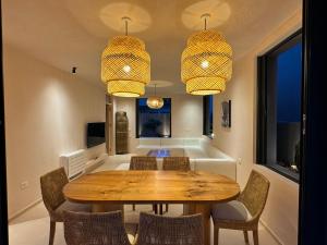 a dining room with a table and chairs at Drymades Olea Villa U16 in Gjilek
