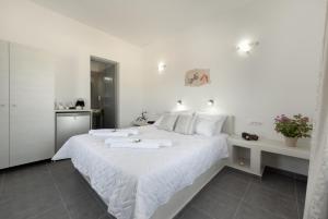 A bed or beds in a room at Pancratium Villas & Suites