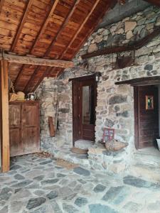 a stone house with a door and a stone floor at A l'Orée du Bois - Family - Entre lacs et montagnes in Séchilienne