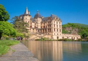 a large castle sitting next to a body of water at A l'Orée du Bois - Family - Entre lacs et montagnes in Séchilienne